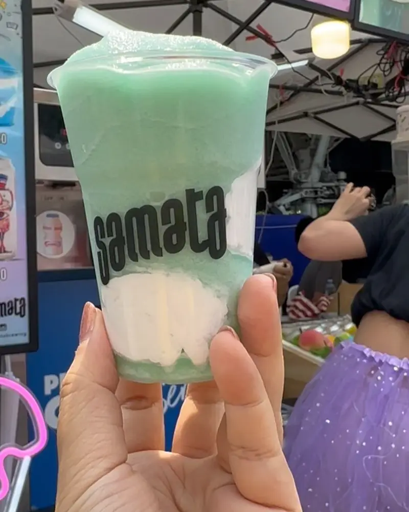 Mint green Samata slurpee held at an outdoor market